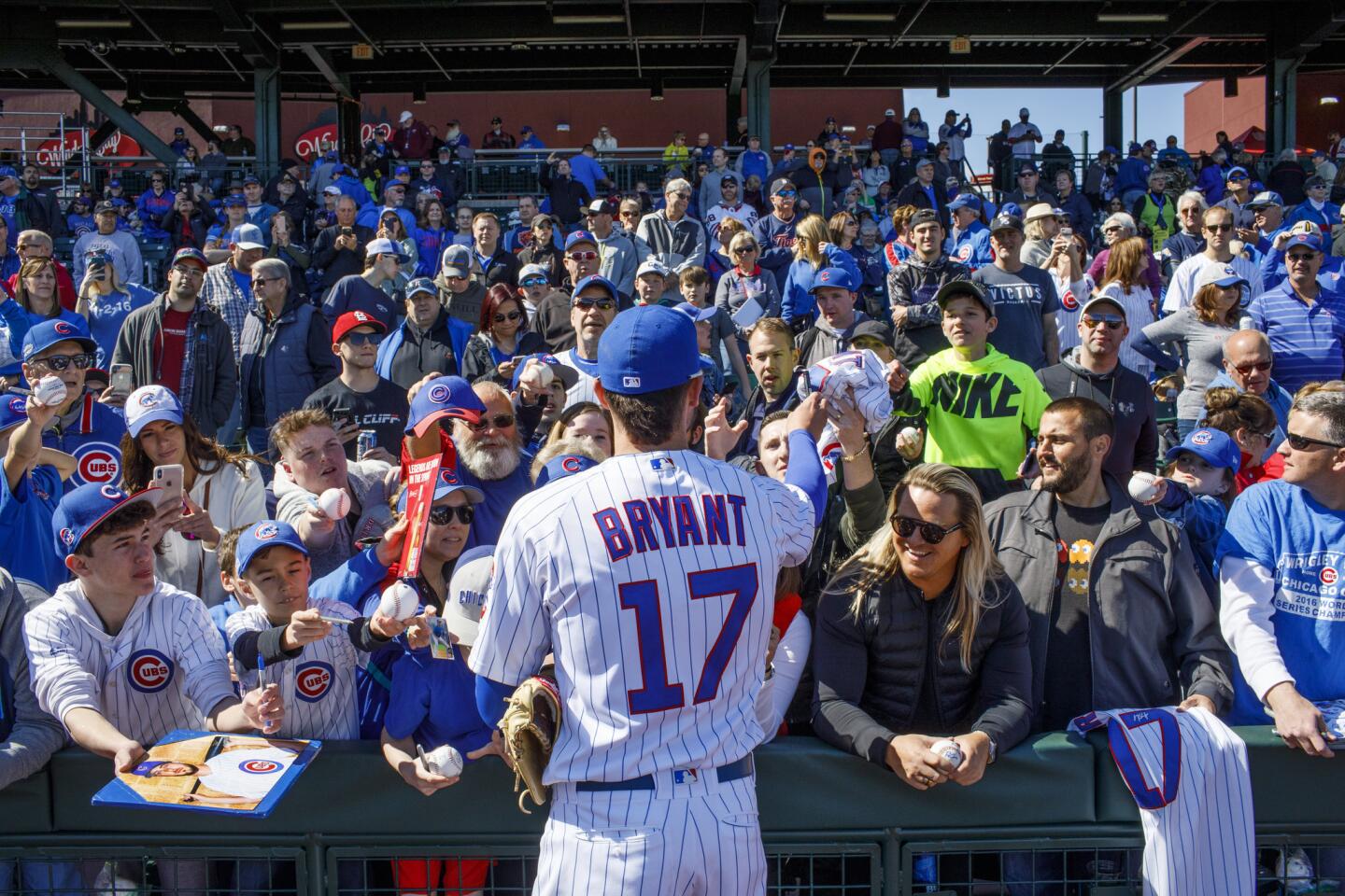 Kris Bryant signs autographs before a spring training game against the Brewers at Sloan Park in Mesa, Ariz., on Saturday Feb. 23, 2019.