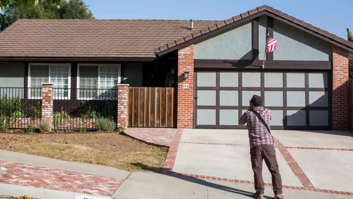 A photographer takes pictures of the home of nightclub shooter Ian David Long in Newbury Park.