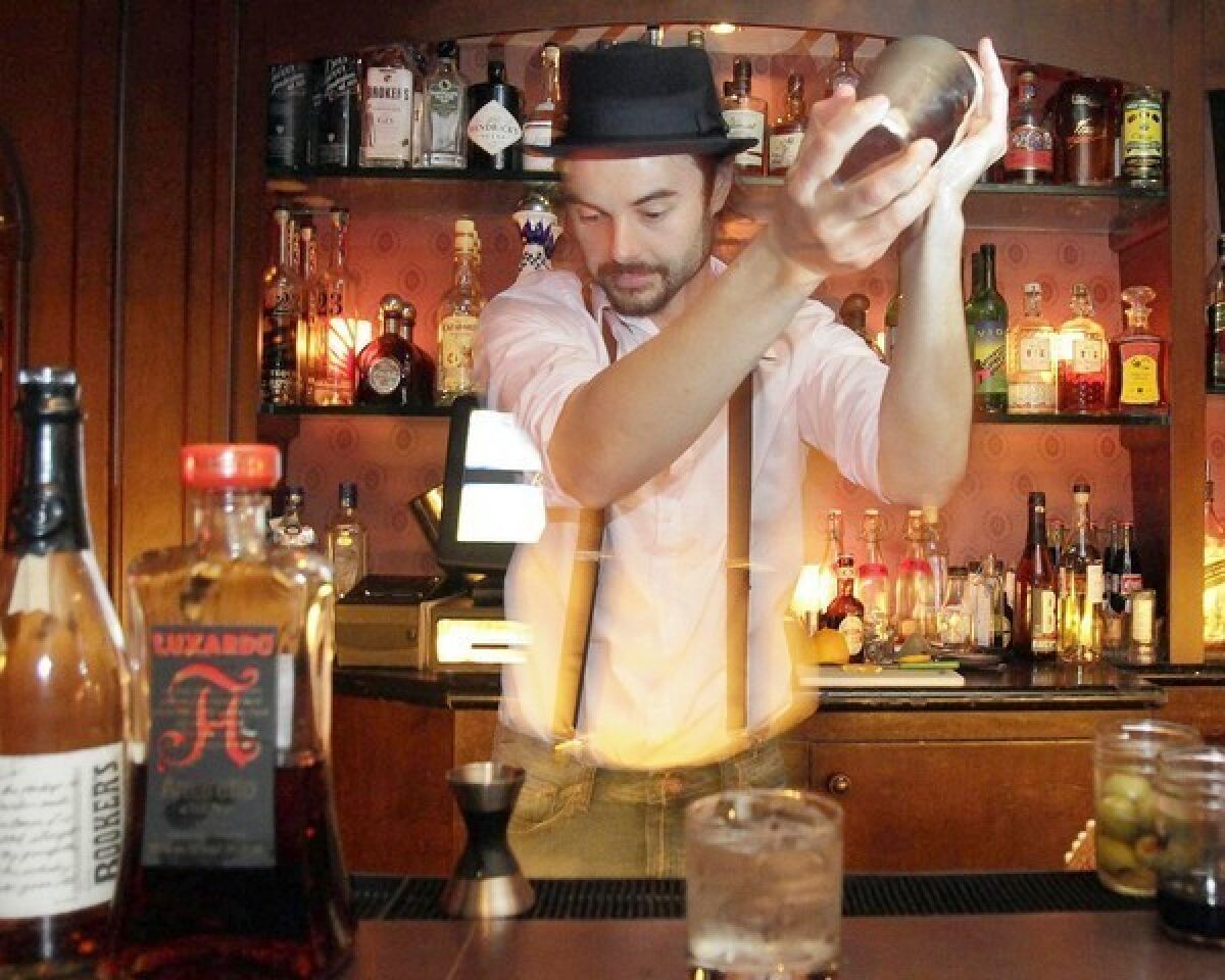 Brandon Reynolds Ristaino mixes up a drink behind the bar at Del Monte Speakeasy.
