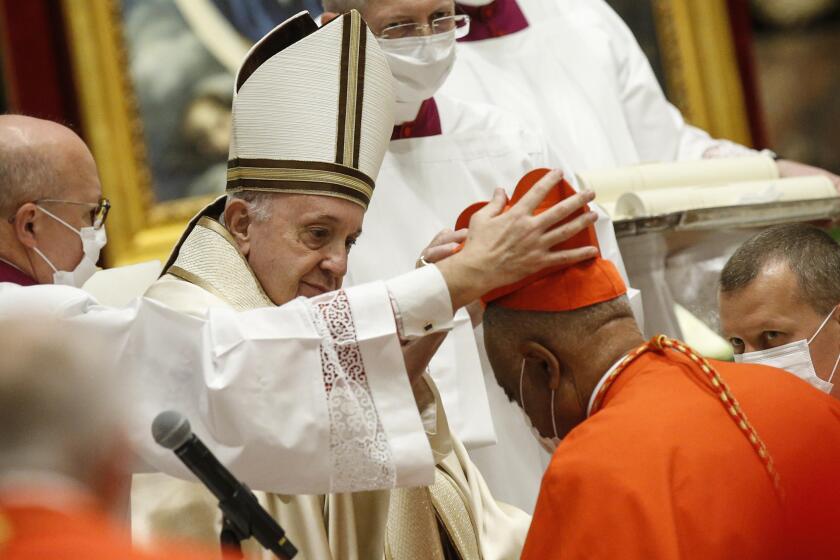American newly Cardinal Wilton D. Gregory receives his biretta as he is appointed cardinal by Pope Francis, during a consistory ceremony where 13 bishops were elevated to a cardinal's rank in St. Peter’s Basilica at the Vatican, Saturday, Nov. 28, 2020. (Fabio Frustaci/POOL via AP)