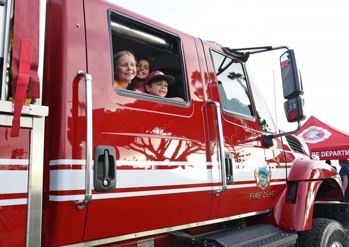 Youngsters look out the high window of Laguna Beach fire engine 302.