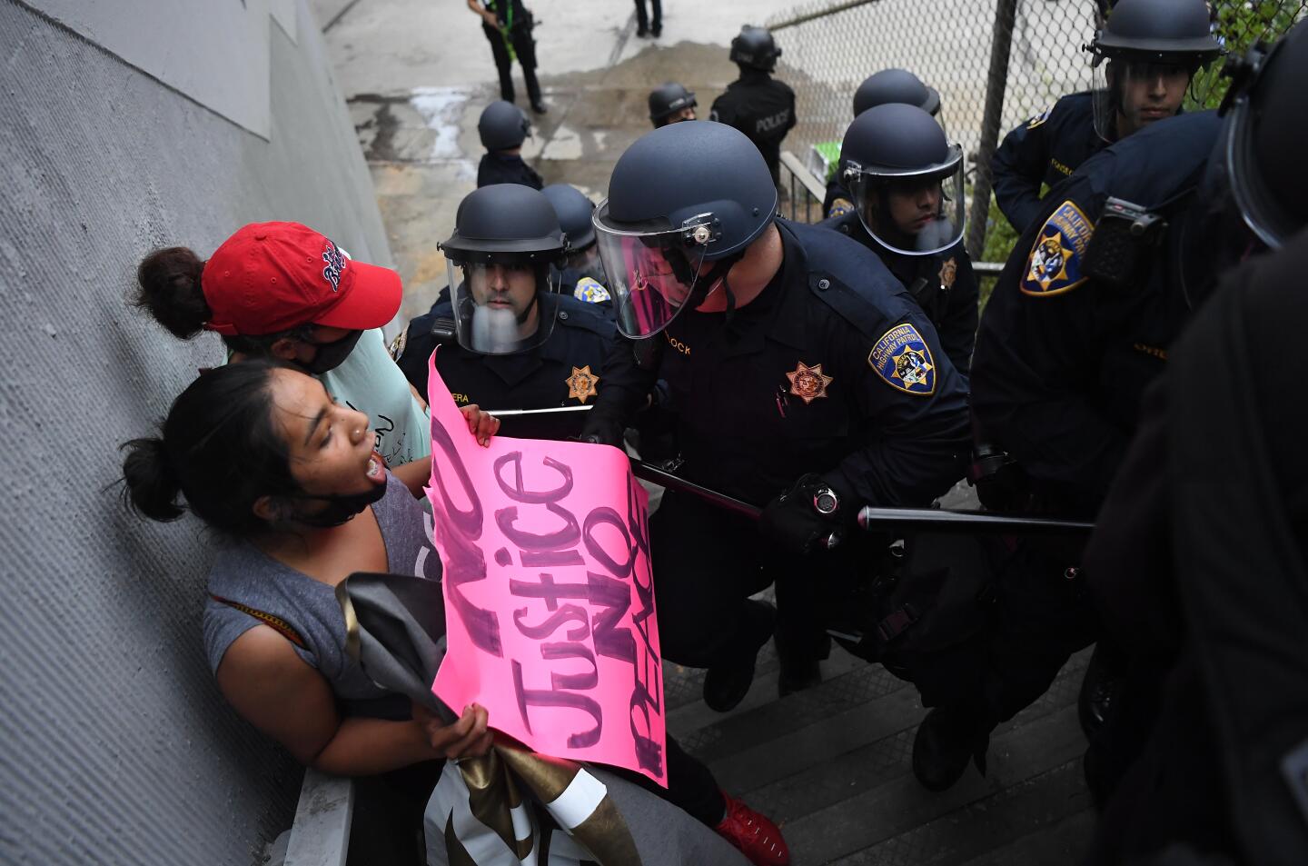 Protesters are escorted off the northbound 110 Freeway in downtown Los Angeles on Friday.