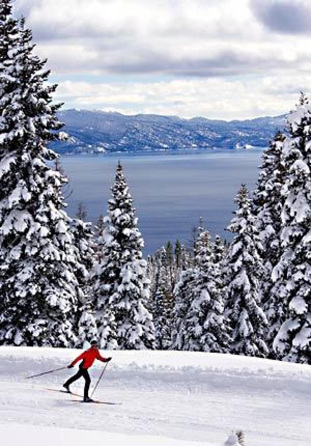 A cross-country skier strides on a trail at Northstar overlooking Lake Tahoe.