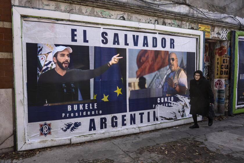 A woman walks past a billboard promoting Labor Party presidential candidate Santiago Cuneo, alongside an image of El Salvador's President Nayib Bukele, in Buenos Aires, Argentina, Tuesday, May 9, 2023. Cuneo says he seeks to emulate Bukele's model of government. General elections are scheduled to be held in Argentina on Oct. 22. (AP Photo/Rodrigo Abd)