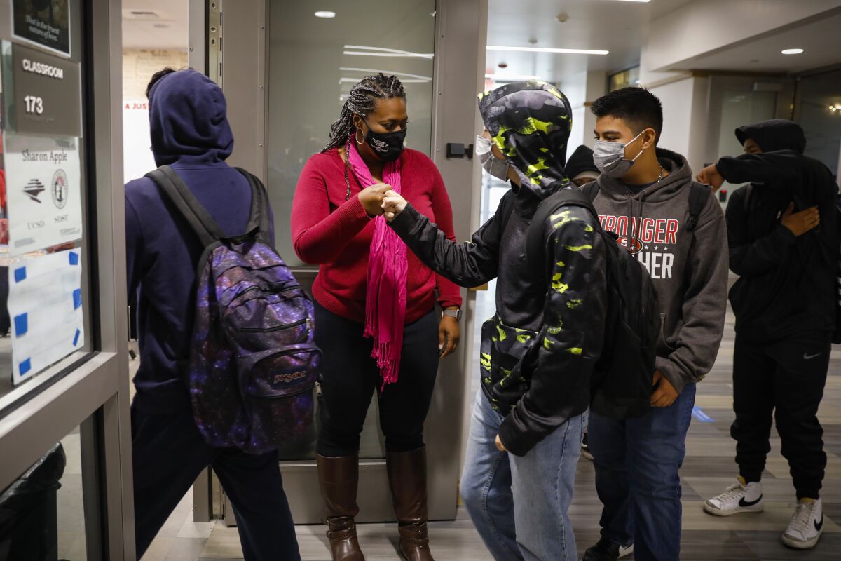 Hoover High teacher Sharon Apple greets ninth grade students as they enter her class rom for Introduction to Ethnic Studies