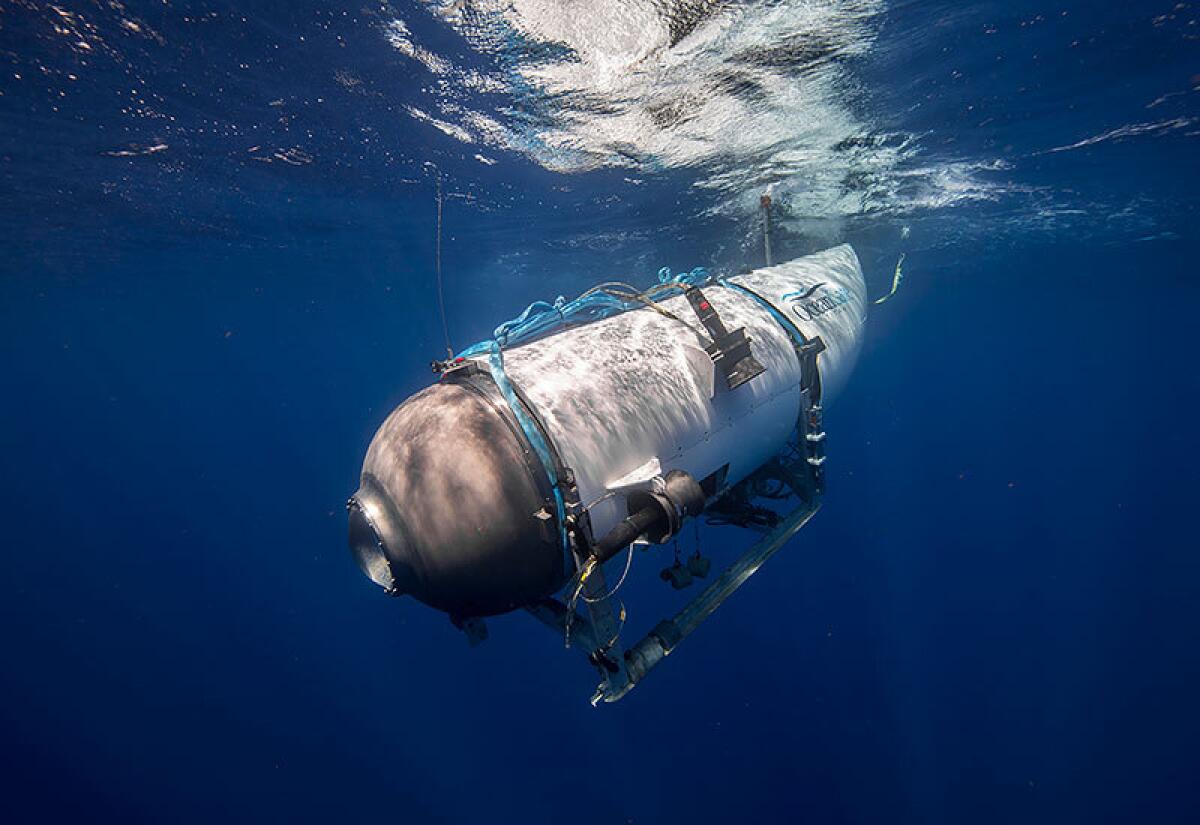 A tourist submersible descends into the sea.