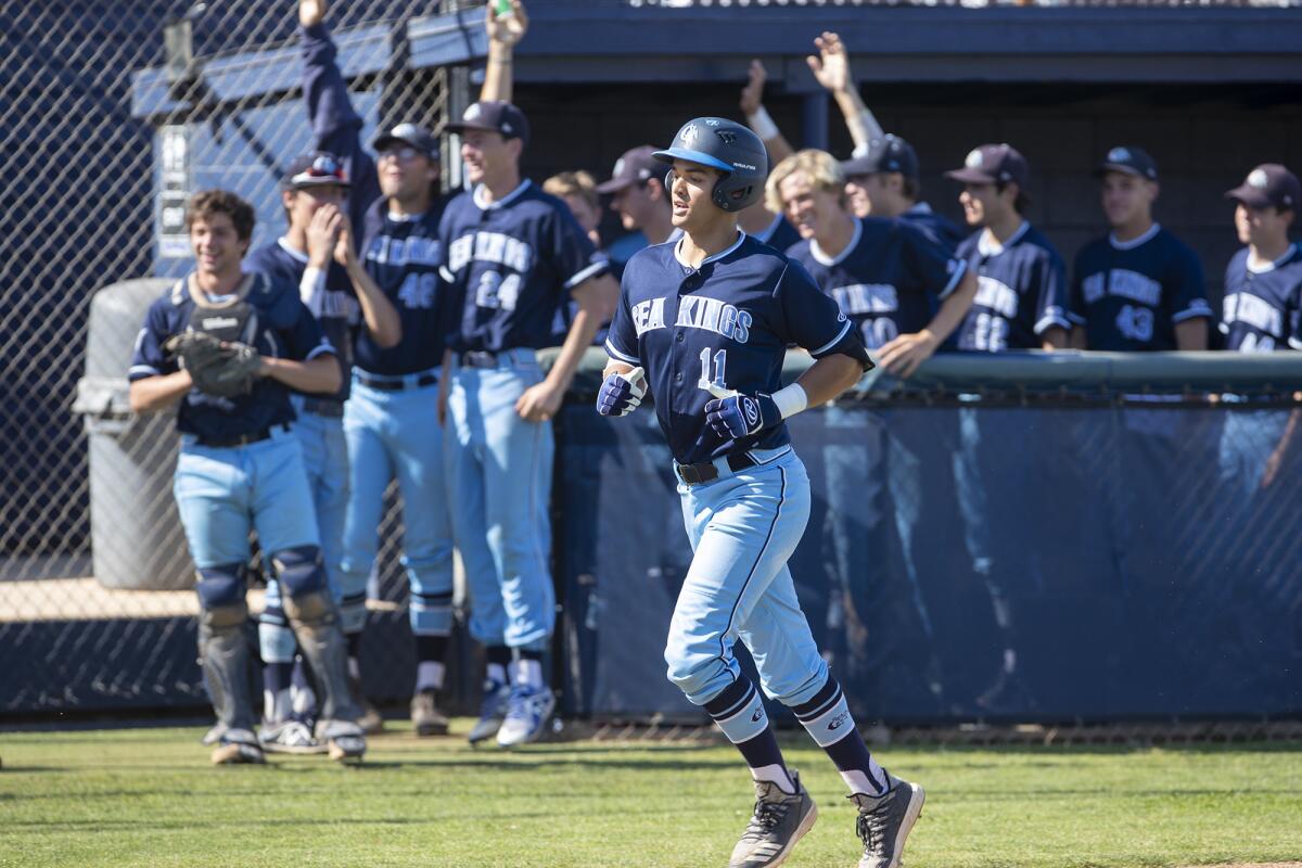 Corona del Mar's Reece Berger trots home after hitting a home run in the third inning during a Wave League game on April 16. 