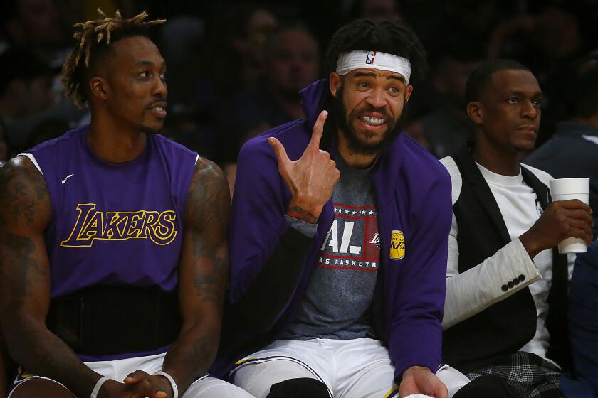 LOS ANGELES, CALIF. - NOV. 10, 2019. Lakers Dwight Howard, left, JaVale McGee and Rajon Rondo on the bench during the second half against the Raptors on Sunday night, Nov. 10, 2019. (Luis Sinco/Los Angeles Times)