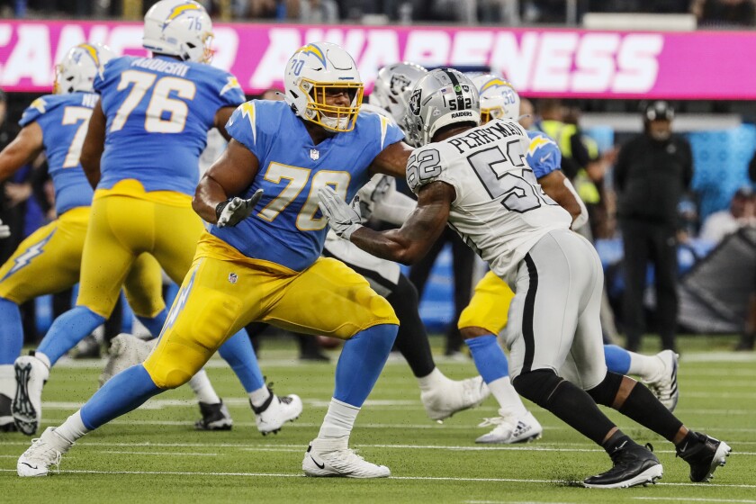 Chargers offensive tackle Rashawn Slater blocks Las Vegas Raiders linebacker Denzel Perryman.