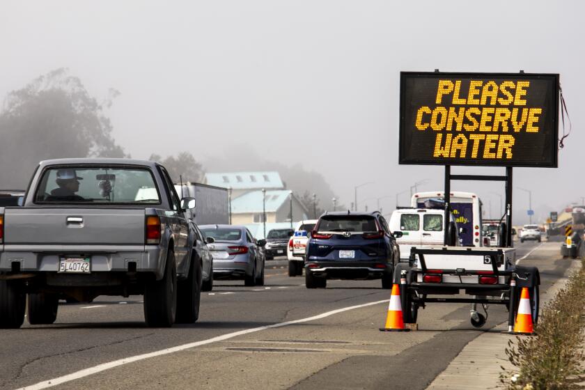 Fort Bragg, CA - August 11: A traffic sign along Highway 1 in Fort Bragg, CA, rotates messages, with "Please Conserve Water," and "Stage 3 Emergency," alerting drivers to the town's move to a stage 3 water emergency, an overall 20-30% reduction in water use, since the emergency was first declared in April, photographed Wednesday, Aug. 11, 2021. (Jay L. Clendenin / Los Angeles Times)