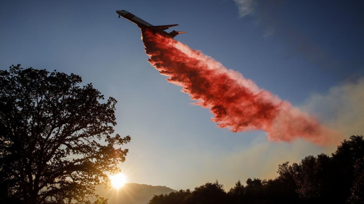 An air tanker drops fire retardant ahead of the River fire in Lakeport, Calif.