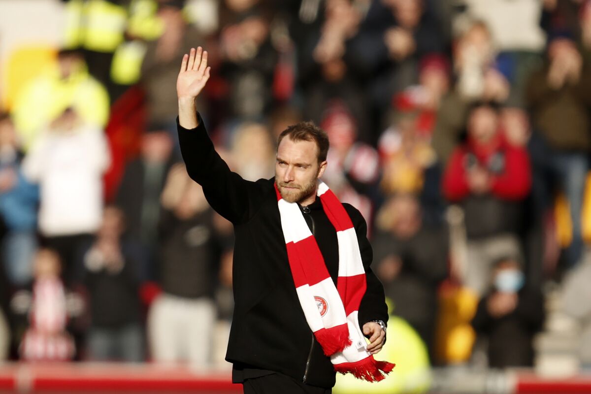 Brentford's Christian Eriksen waves to the spectators ahead of the English Premier League soccer match between Brentford and Crystal Palace at Brentford Community stadium in London, Saturday, Feb. 12, 2022. (AP Photo/David Cliff)
