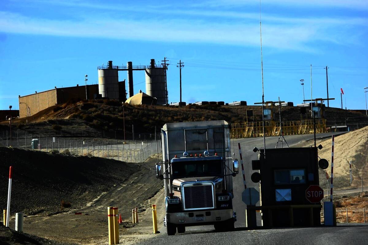 A truck exits the Chemical Waste Management site near Kettleman City, Calif. The facility, which has a history of violations, has agreed to pay $311,000 for not reporting 72 spills of hazardous materials in the last four years.