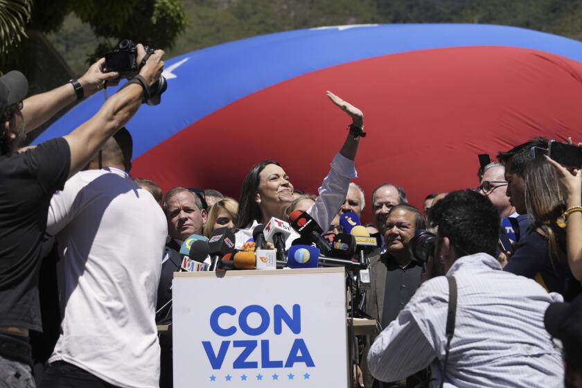 Opposition coalition presidential hopeful Maria Corina Machado gives a press conference outside her campaign headquarters in Caracas, Venezuela, Monday, Jan. 29, 2024, days after the country's highest court upheld a ban on her presidential candidacy. (AP Photo/Ariana Cubillos)
