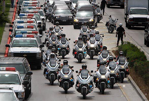 A police motorcade escorts seven hearses through traffic in Tijuana, en route to ciy hall for a memorial for the seven police officers slain by gunmen the night of April 27, 2009. Full Coverage: Mexico Under Seige Related story: 7 police officers die in Tijuana attacks