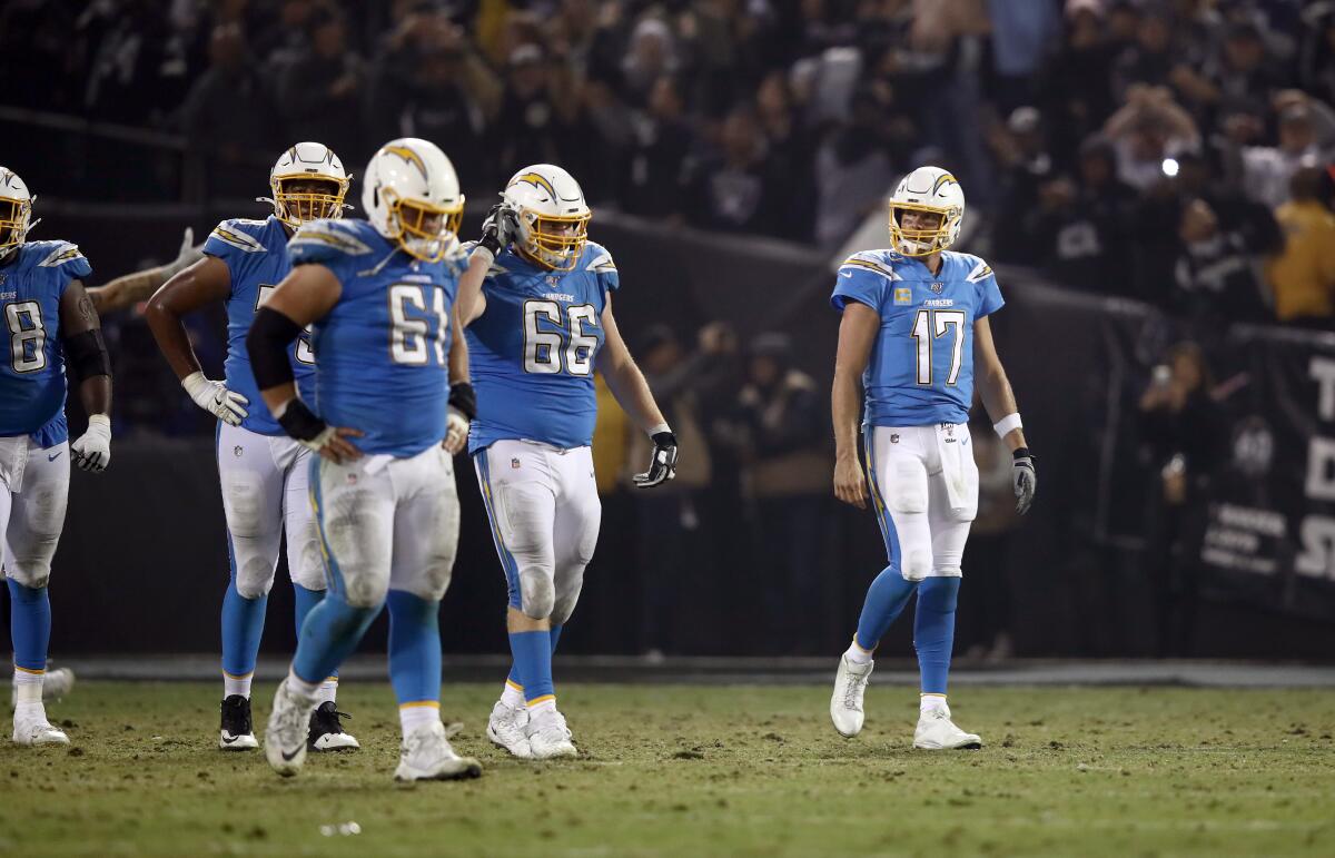Chargers quarterback Philip Rivers walks off the field after having a pass intercepted by the Raiders late in a game on Nov. 7 at RingCentral Coliseum.