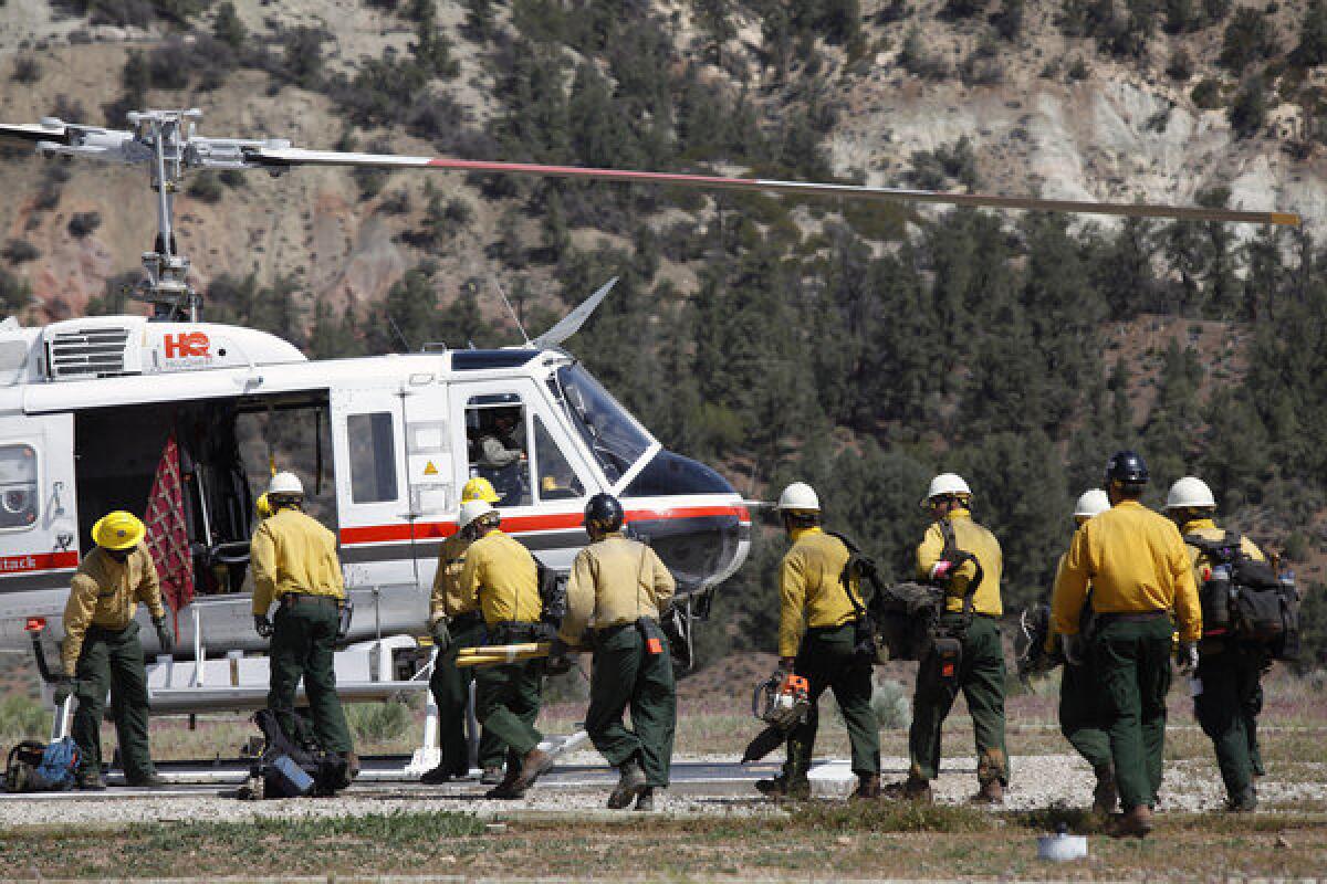 Crews in the Los Padres National Forest board a helicopter that will drop them on top of mountains to fight the Grand fire.