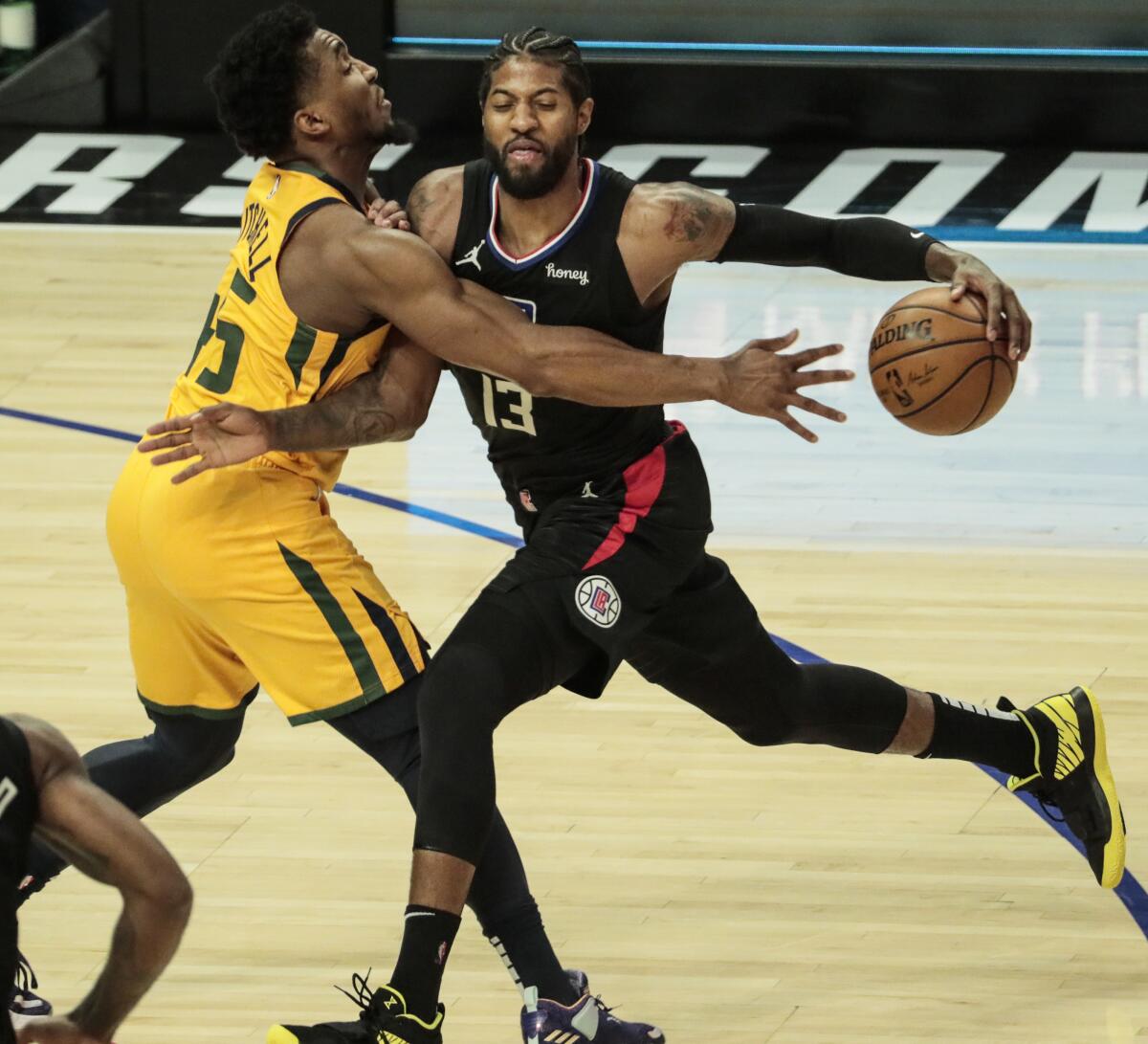 Utah's Donovan Mitchell (45) struggles to cover Clippers' Paul George during Game 4 at Staples Center.