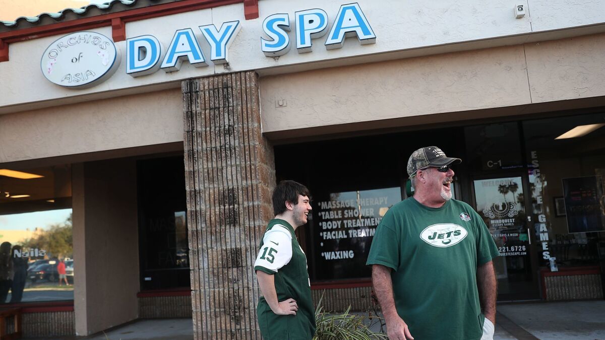 New York Jets fans Matthew Gizze, left, and Kevin Brown were among the many who stopped by the Orchids of Asia Day Spa on Feb. 22.