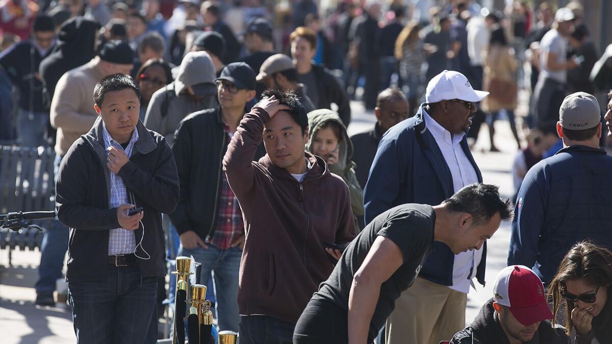 People in Santa Monica wait for hours in 2016 to put down a deposit on a Tesla Model 3.