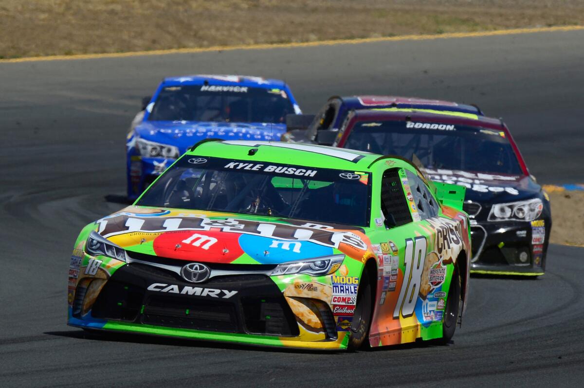 NASCAR driver Kyle Busch leads a pack of cars through turns at Sonoma Raceway on Sunday during the Toyota Save Mart 350.