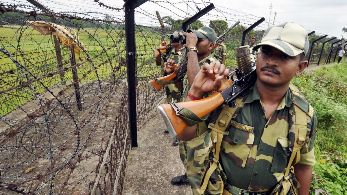 Indian Border Security Force personnel patrol the Bangladesh border at the Lankamura post in Agartala.