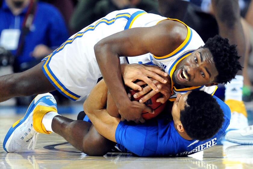 UCLA's Isaac Hamiloton battles for a loose ball with Kentuky's Skal Labissiere in the second half at Pauly Pavillion on Thursday.