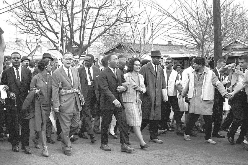 Martin Luther King Jr. and his wife Coretta Scott King lead others on the Selma to Montgomery marches held in support of voting rights in Alabama in March 1965.