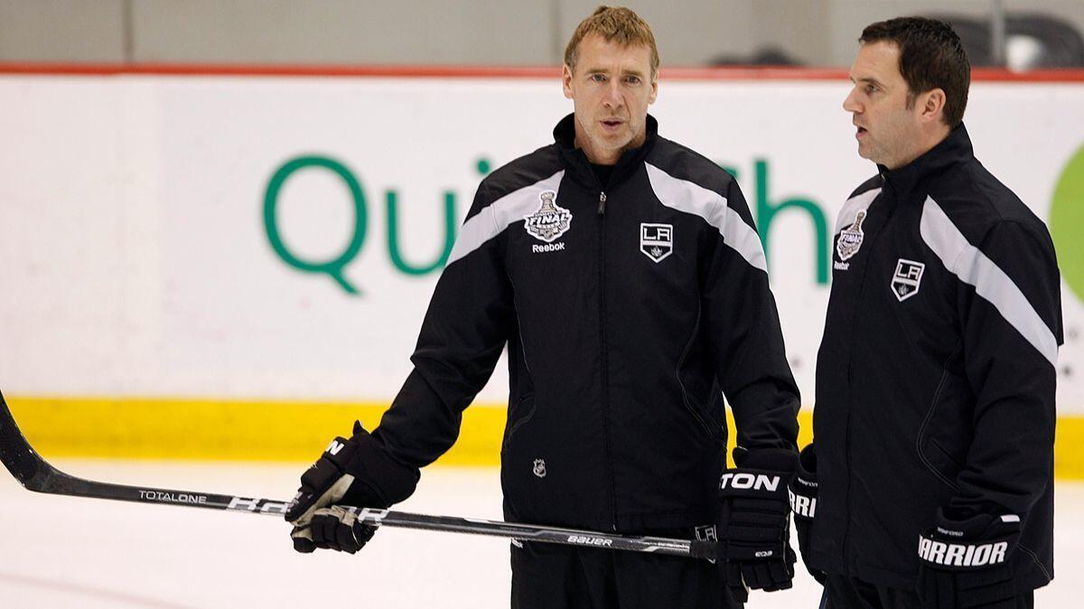 Kings goalie coach Bill Ranford, right, pictured in 2012 with Kings assistant Bernie Nicholls, said nearly 1,000 people expressed interest in the opening for an emergency goaltender. The Kings auditioned about 35 hopefuls Wednesday.
