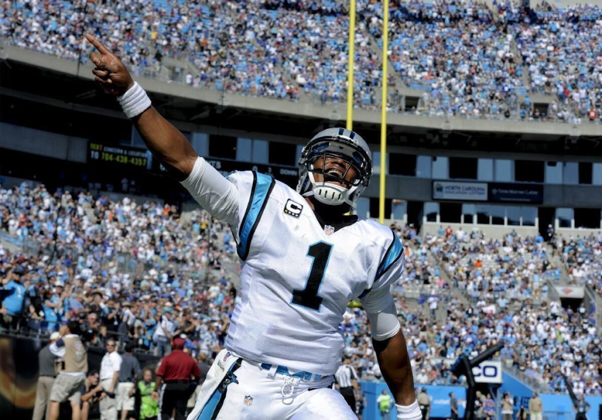Carolina Panthers quarterback Cam Newton celebrates a touchdown Sunday in Charlotte, N.C.