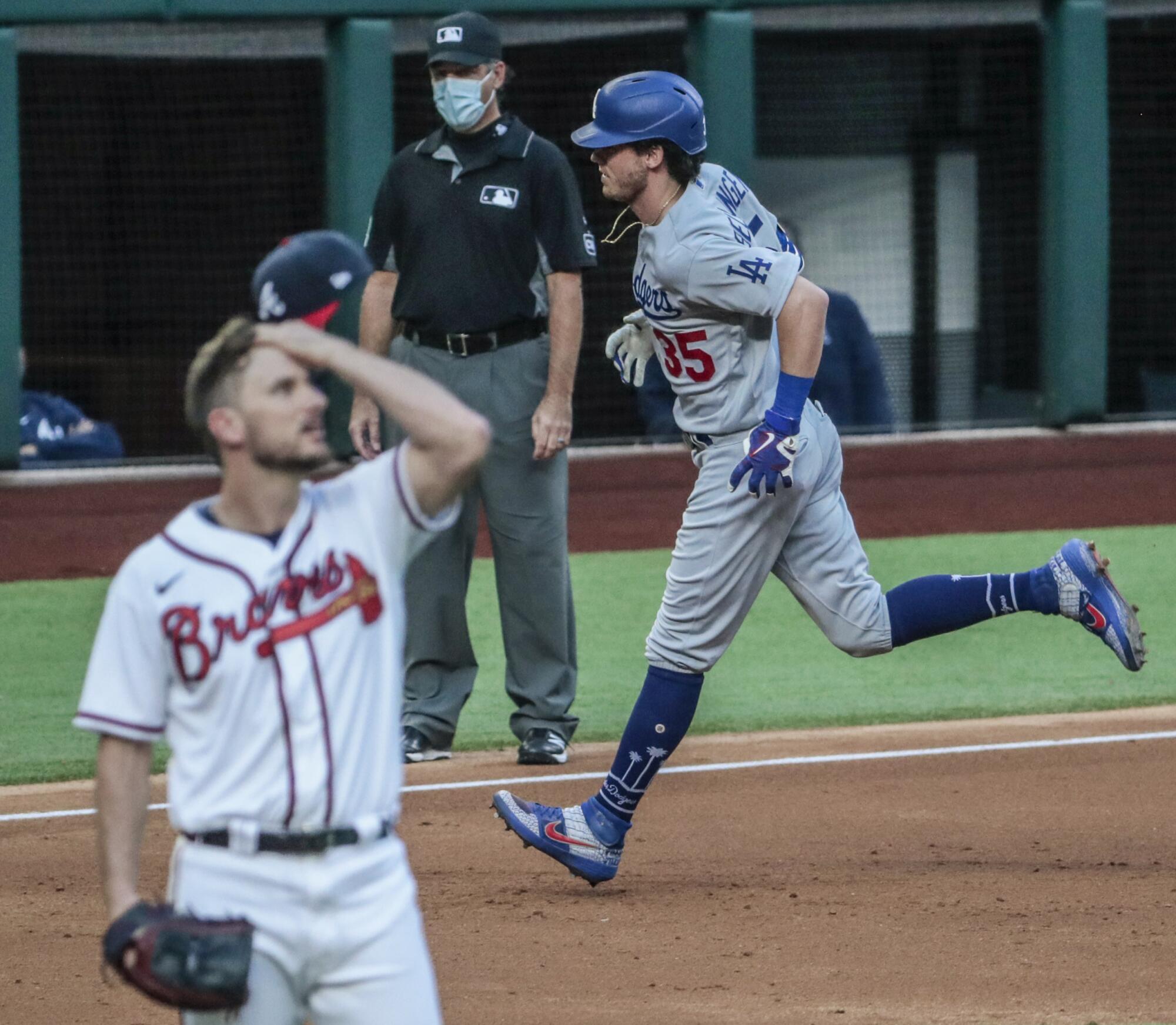 Dodgers center fielder Cody Bellinger circles the bases after hitting a home run off Braves relief pitcher Grant Dayton.