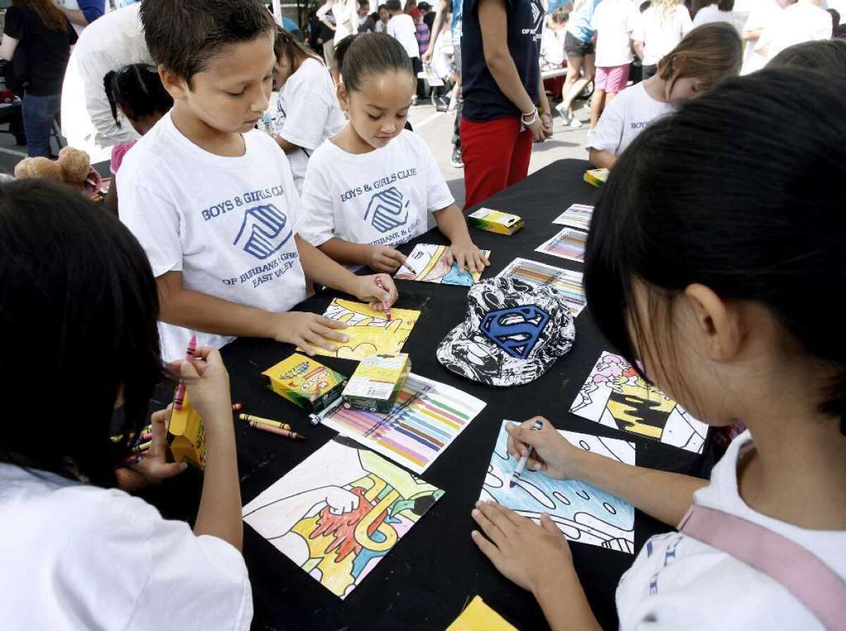 Children color some of the 200 tiles that made up a Cartoon Network's 20th Anniversary mural at the Burbank Boys and Girls Club last year.