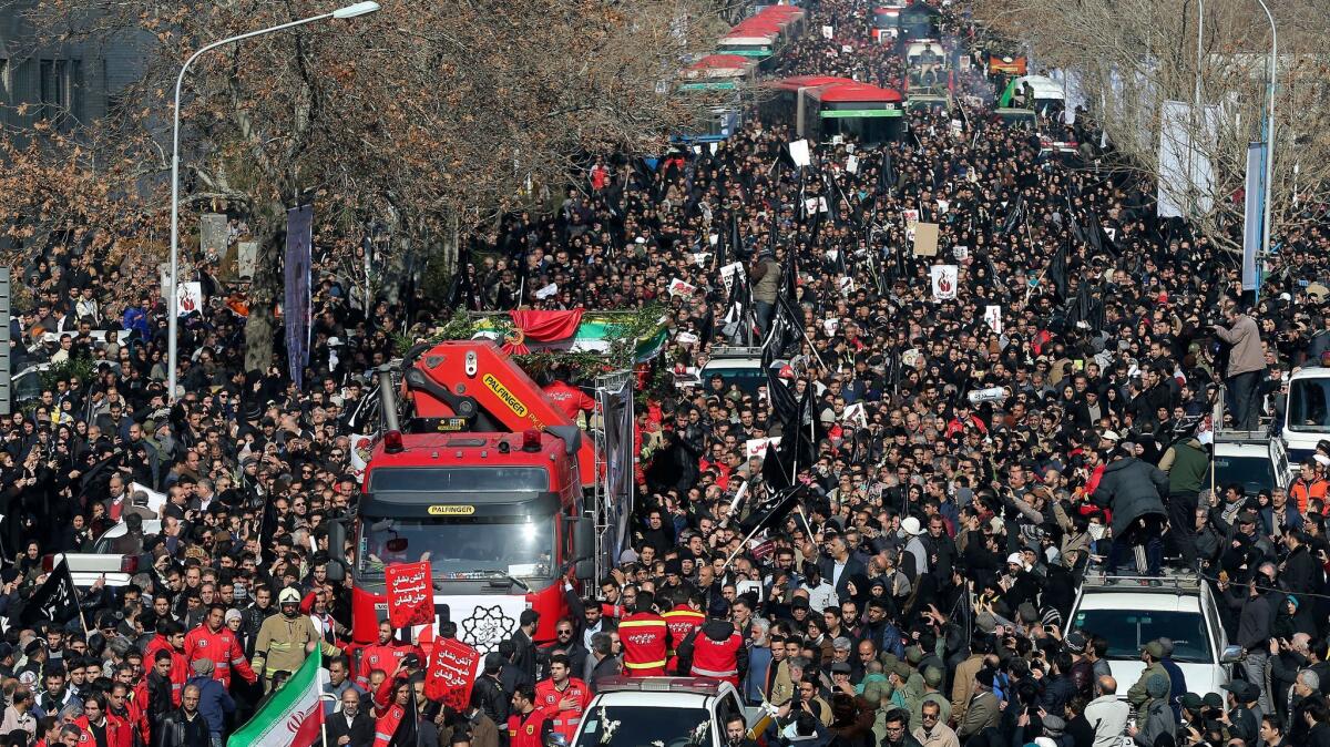 Iranians in Tehran attend the funeral of the firefighters .