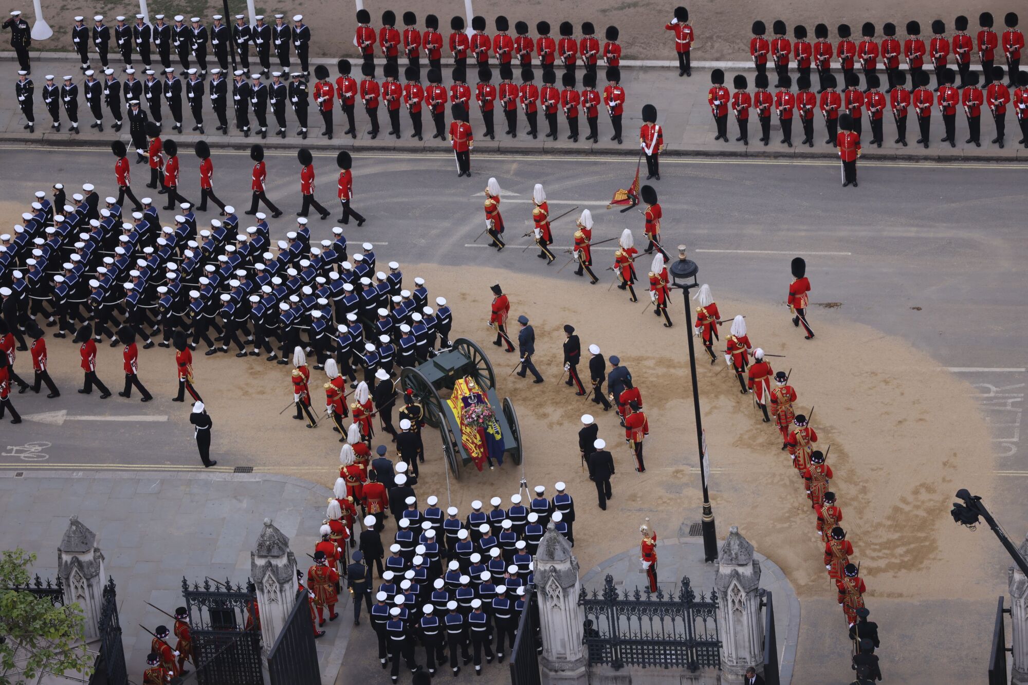 General view of the Queen's coffin escorted by troops.