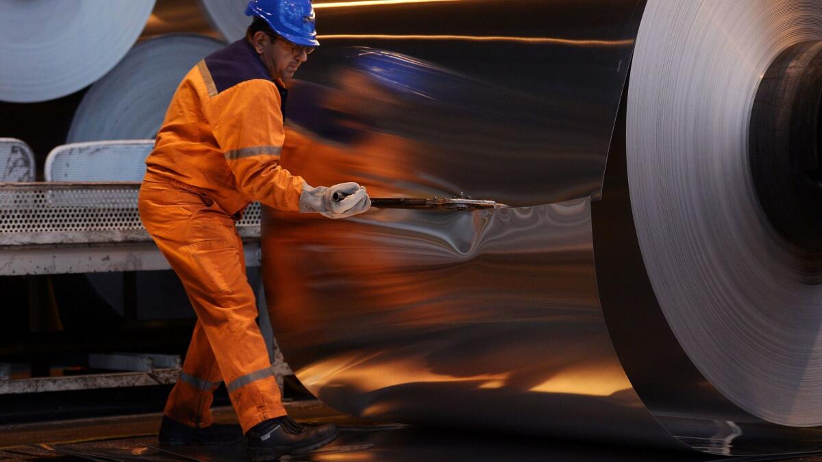 A worker cuts into an aluminium roll at the Constellium factory in the eastern French city of Biesheim.