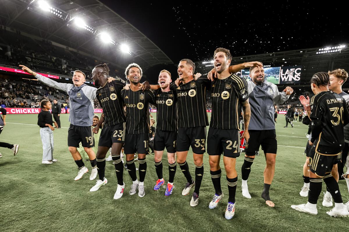 LAFC players embraced and celebrate on the pitch at BMO Stadium after finishing atop the Western Conference