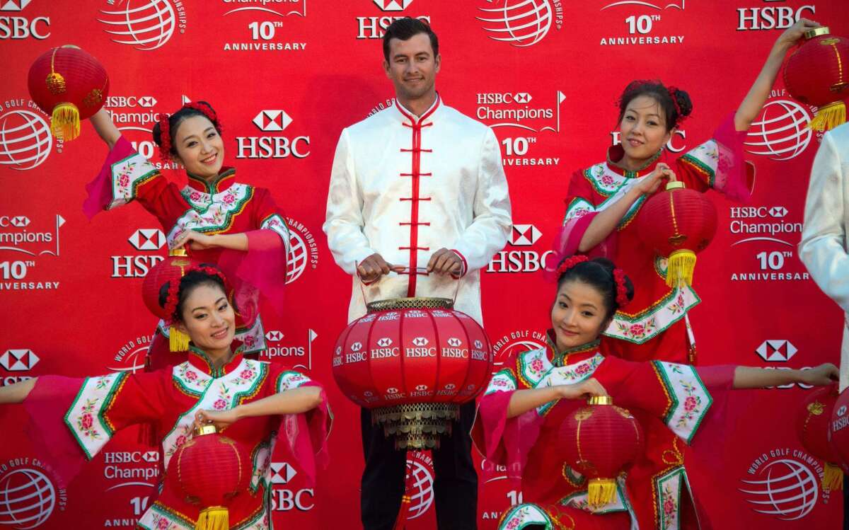 Australian golfer Adam Scott poses at a photo call for the HSBC Champions tournament Tuesday on the historic Bund in Shanghai.