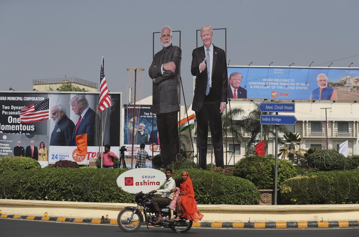Cut-out images of President Trump and Indian Prime Minister Narendra Modi are seen on a roadside in Ahmedabad, India, on Sunday.
