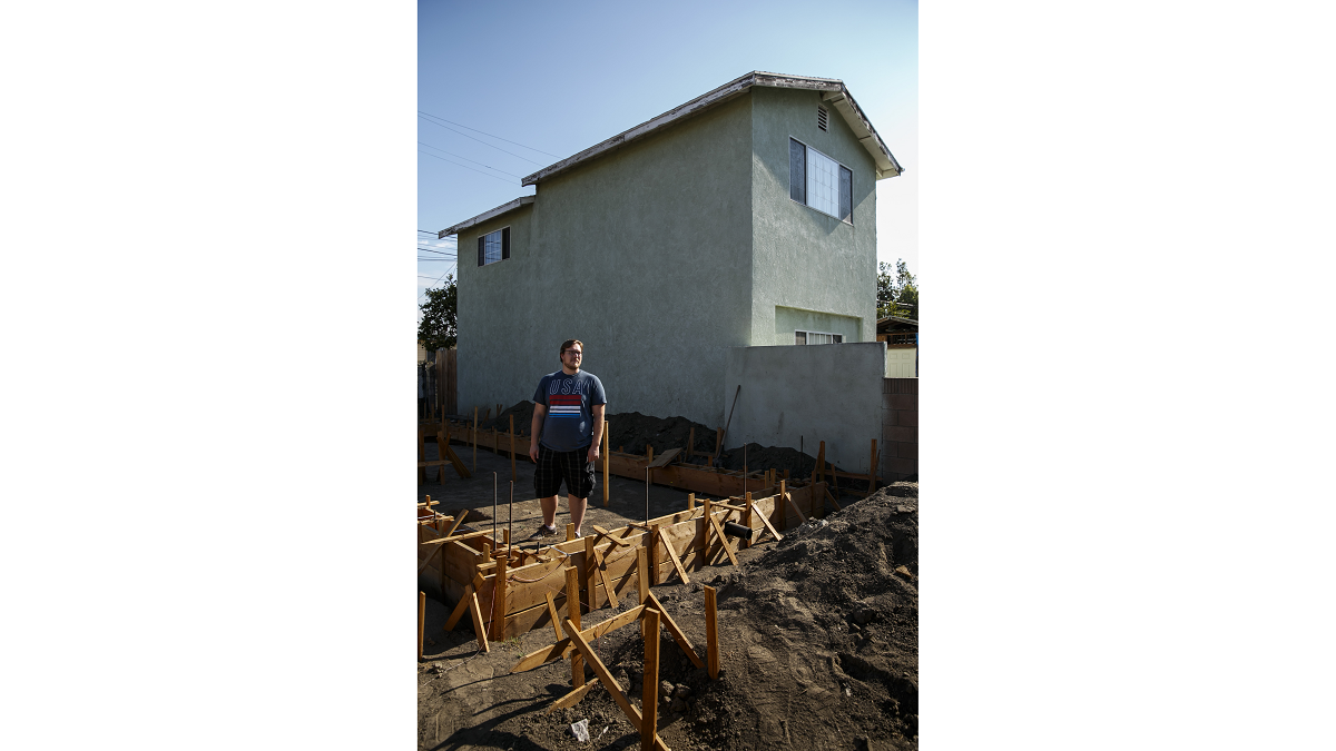 John Gregorchuck stands amid construction of a secondary living unit in his Los Angeles backyard. In Glendale, the City Council took the first steps of lowering the fees associated with the construction of accessory-dwelling units.