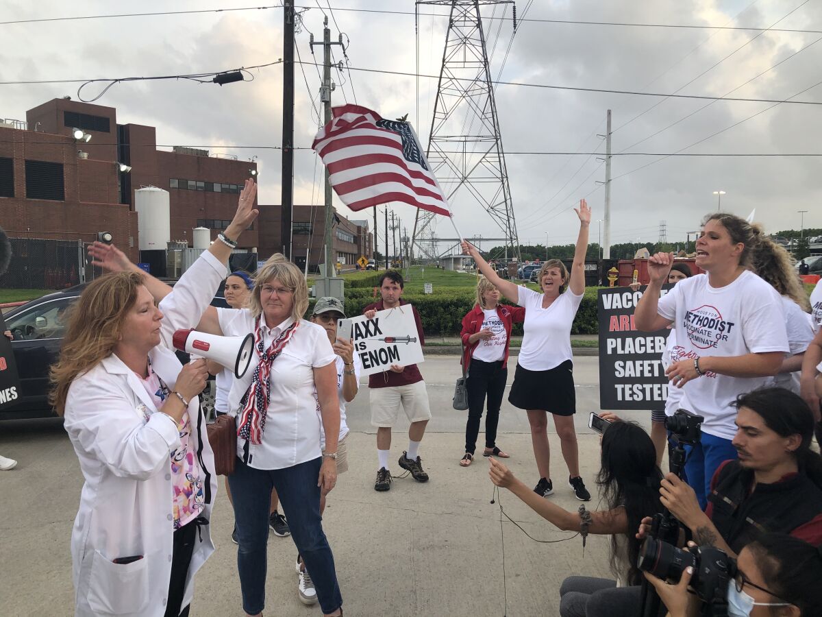 Houston Methodist Hospital nurse Jennifer Bridges, right, leads a COVID vaccine protest