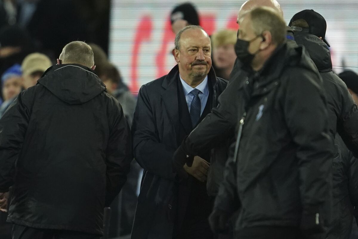 Everton's head coach Rafael Benitez, center, leaves the pitch at the end of the English Premier League soccer match between Everton and Liverpool at Goodison Park in Liverpool, England, Wednesday, Dec. 1, 2021. Liverpool won 4-1. (AP Photo/Jon Super)