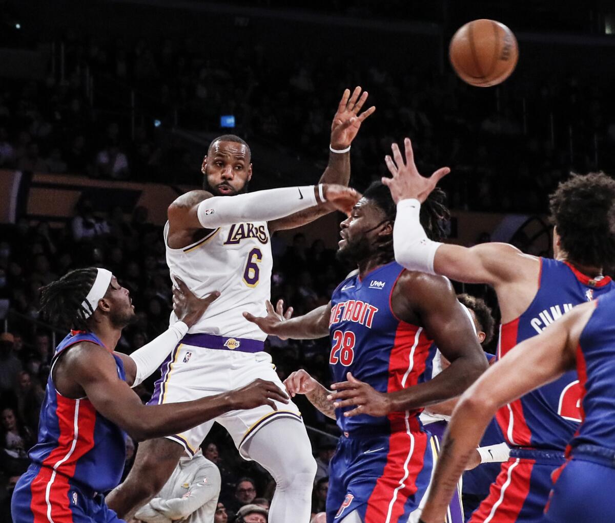  Lakers forward LeBron James passes the ball over Detroit Pistons center Isaiah Stewart.
