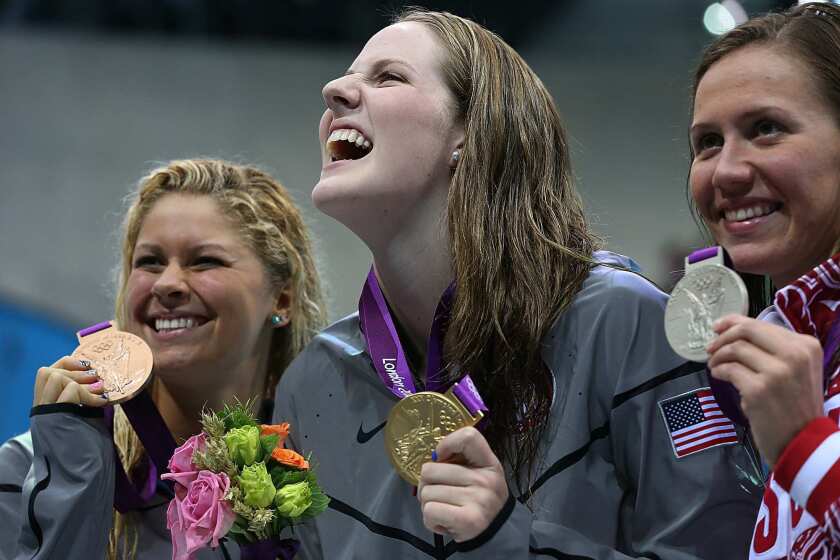 U.S. swimmer Missy Franklin, center, enjoys the medal ceremony with teammate Elizabeth Beisel, left, and Russia's Anastasia Zueva. Franklin won the gold, setting a world record of 2:04.06. Beisel took the bronze and Zueva silver.