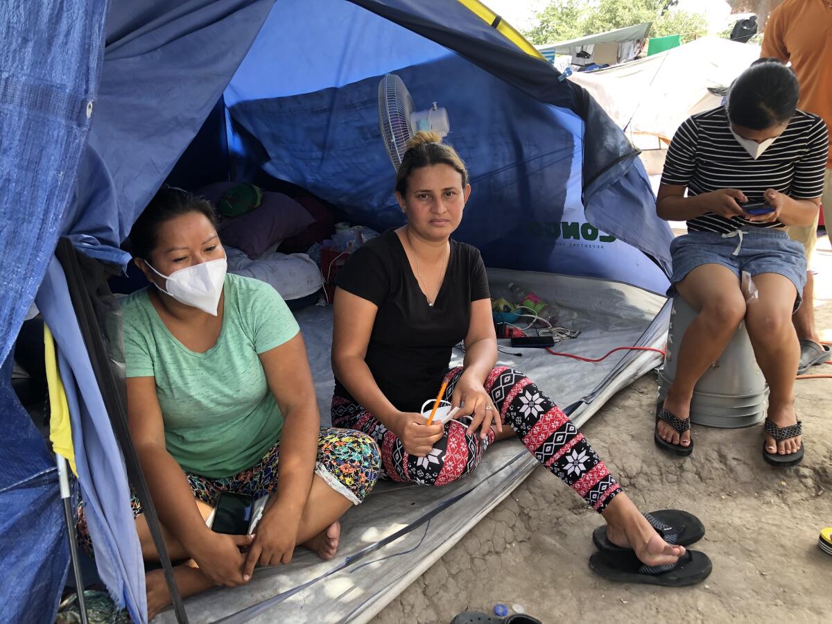 Honduran asylum seeker Lesly Pineda, center, at her tent in Reynosa, Mexico.
