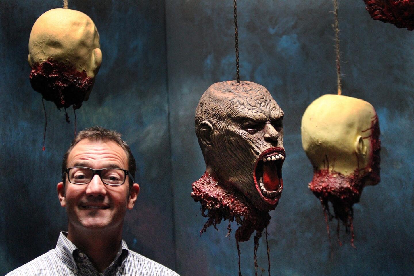 Knott's Berry Farm Halloween Haunt maze designer Todd Faux with some fake heads inside the "Delirium" maze, one of 13 that make up "Knott's Scary Farm."