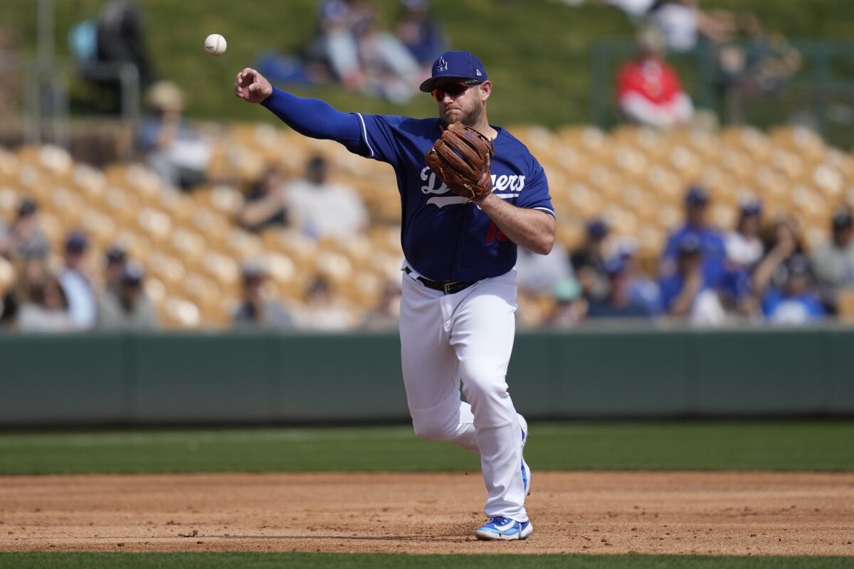 Dodgers third baseman Max Muncy throws to first during a spring game against the San Diego Padres.