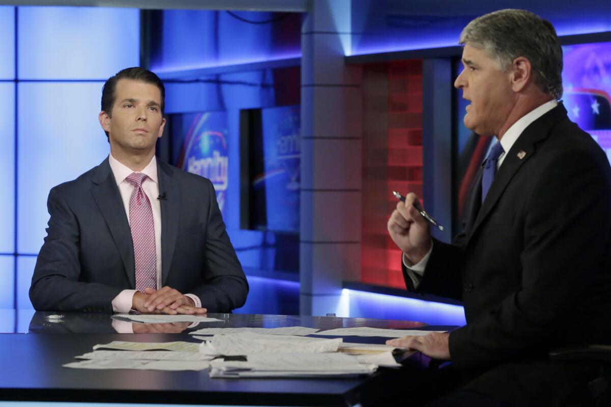 Donald Trump Jr., left, with Sean Hannity on Tuesday.