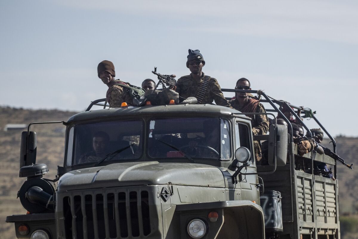 FILE - In this Saturday, May 8, 2021 file photo, Ethiopian government soldiers ride in the back of a truck on a road near Agula, north of Mekele, in the Tigray region of northern Ethiopia. Tigray forces say Ethiopia’s government has launched its threatened major military offensive against them in an attempt to end a nearly year-old war. A statement from the Tigray external affairs office on Monday, Oct. 11 alleged that hundreds of thousands of Ethiopian “regular and irregular fighters” launched a coordinated assault on several fronts. (AP Photo/Ben Curtis, File)