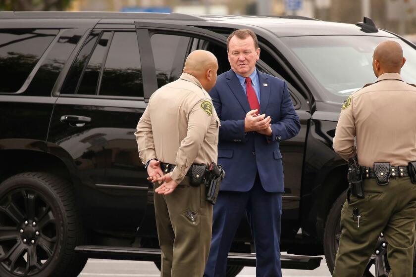 LOS ANGELES, CA - MARCH 16, 2017 - Los Angeles County Sheriff James "Jim" McDonnell talks to LA County Sheriff Deputies on scene as several resources were deployed to a shooting in the parking lot of the Sheriff's Temple Station located at 8838 E Las Tunas Dr in Temple City this Monday morning March 20, 2017 where a man is dead inside his vehicle possibly from a self-inflicted gunshot wound. The shooting was reported about 7:30 a.m. outside the facility and no deputies were injured. (Al Seib / Los Angeles Times)