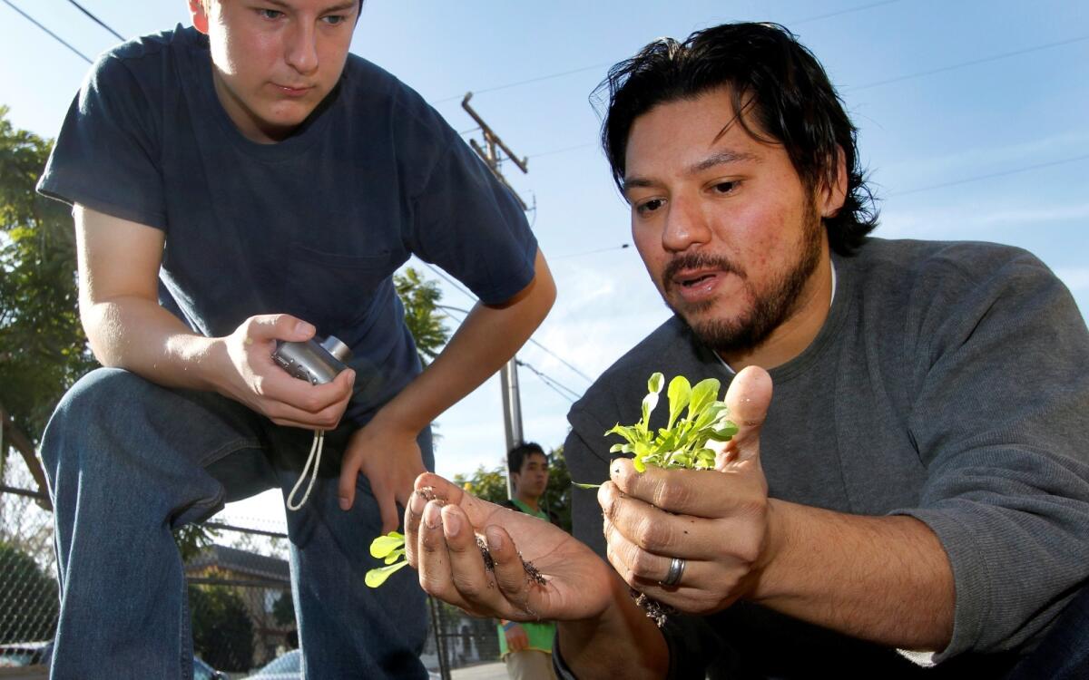 Chef Ray Garcia, right, working at his school garden project in 2010.